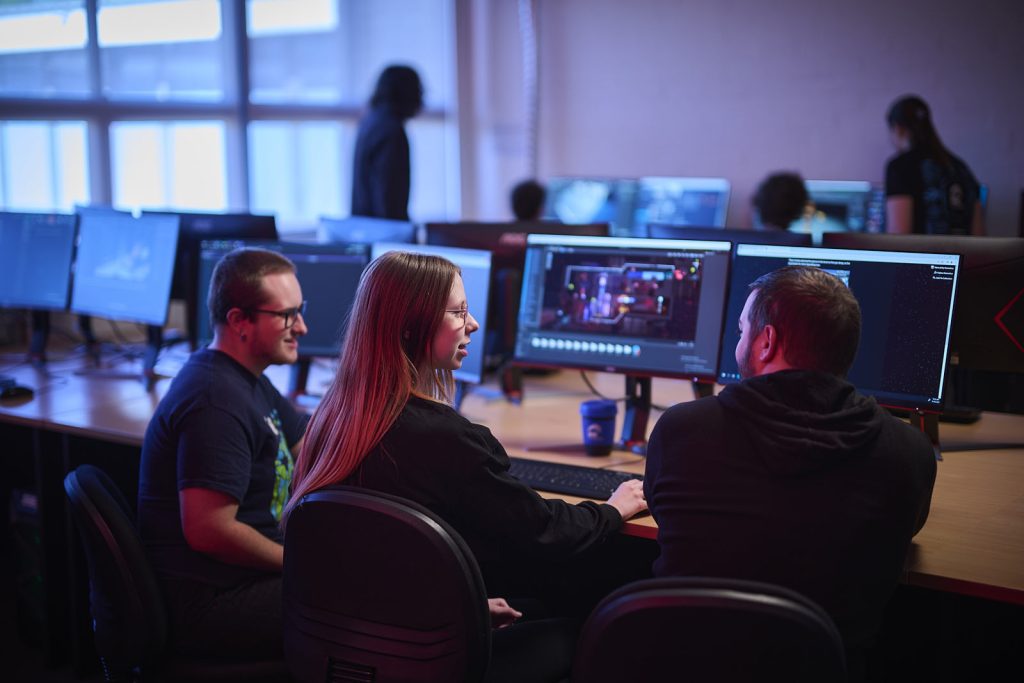 Advertising Curated image of 3 students in a class at the AIE